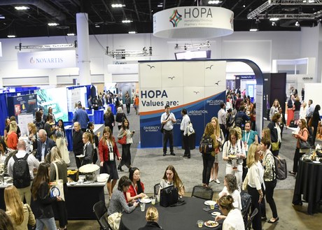 woman talking to man in exhibit hall