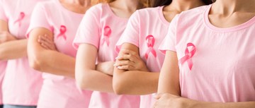 A line of women with breast cancer ribbons on their chests
