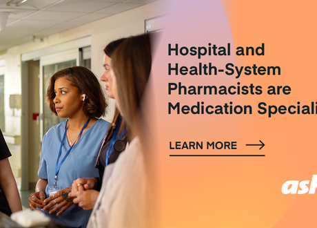 On an orange background, female healthcare workers are huddled in conversation