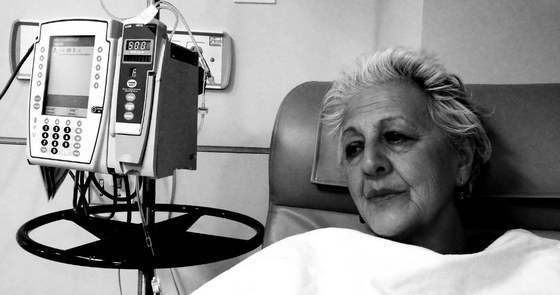 black and white photo of woman of color receiving IV chemo