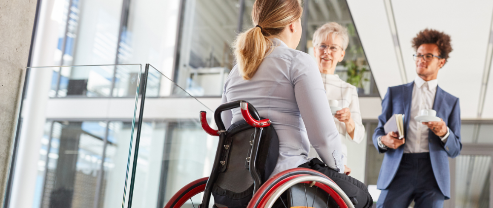 woman in wheelchair with colleagues